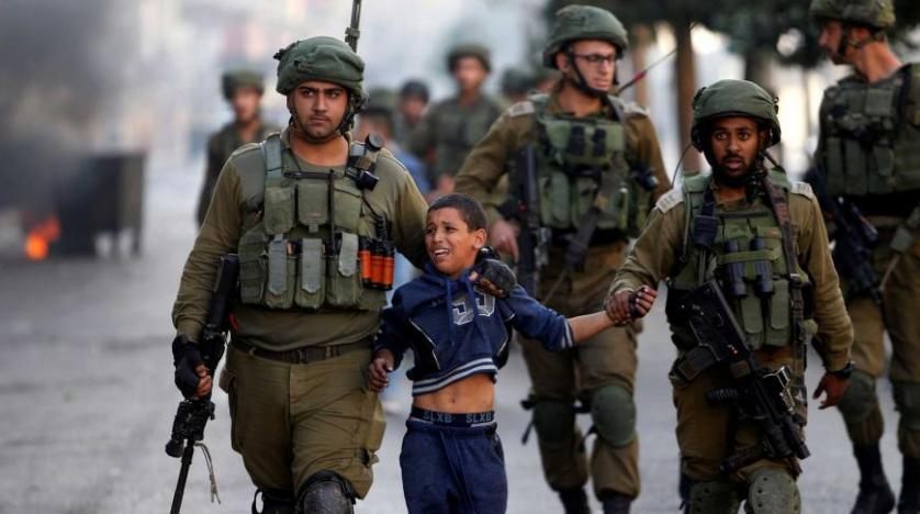 Israeli Occupation Forces detain a Palestinian boy during clashes in the West Bank city of Al-Khalil, Oct. 13, 2017. (Reuters)