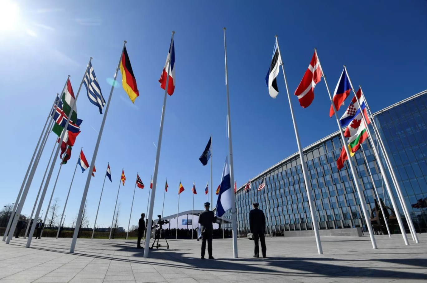 Finnish military personnel install their national flag at the NATO headquarters in Brussels on Tuesday. (AFP)