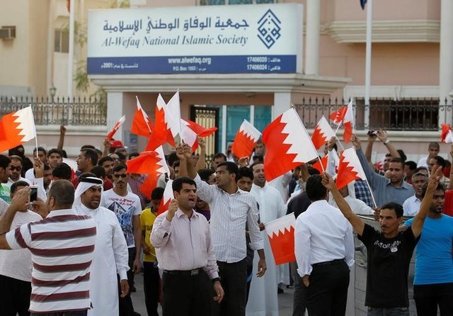 Anti-government protesters shout slogans while holding Bahraini flags during a protest outside Bahrain's leading opposition party Al Wefaq's headquarters May 9, 2012 (Reuters/Hamad Mohammed)
