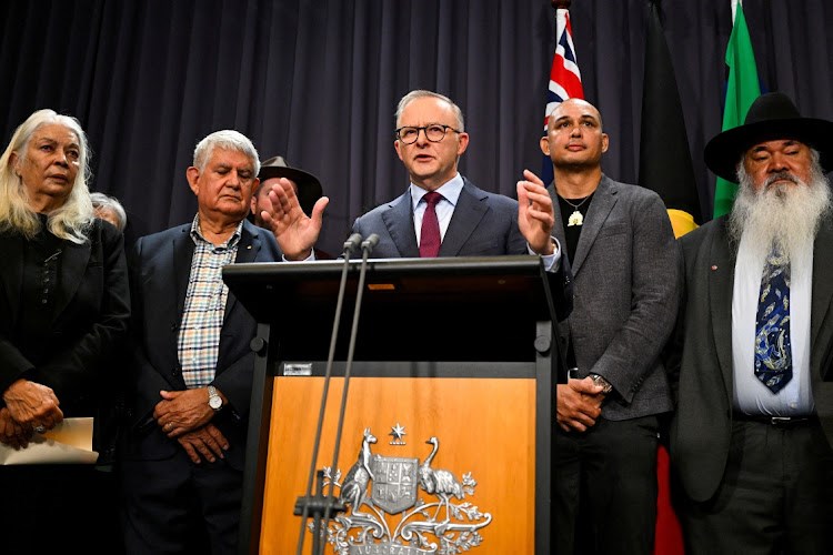 Australian Prime Minister Anthony Albanese, surrounded by members of the First Nations Referendum Working Group, speaks to the media during a news conference at Parliament House in Canberra, March 23, 2023. (Reuters)