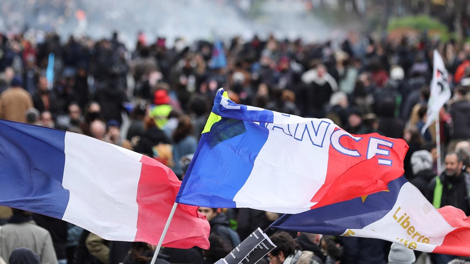 Flags are seen during a demonstration as part of the tenth day of nationwide strikes and protests against French government's pension reform in Paris, France in March 2023 (AFP)