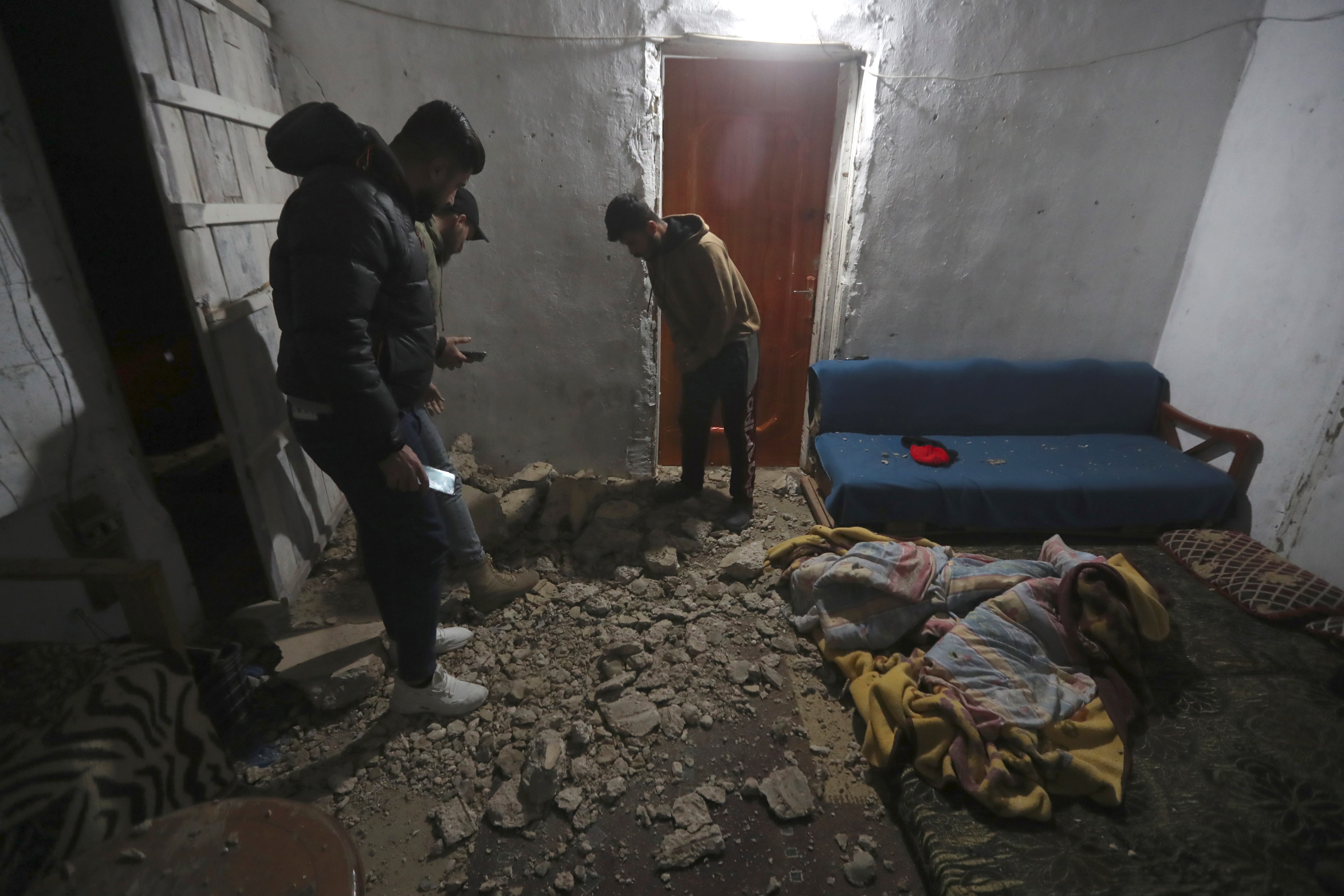Lebanese check a house damaged by an Israeli airstrike, in Qlaileh village, south Lebanon, early Friday, April 7, 2023. (AP)