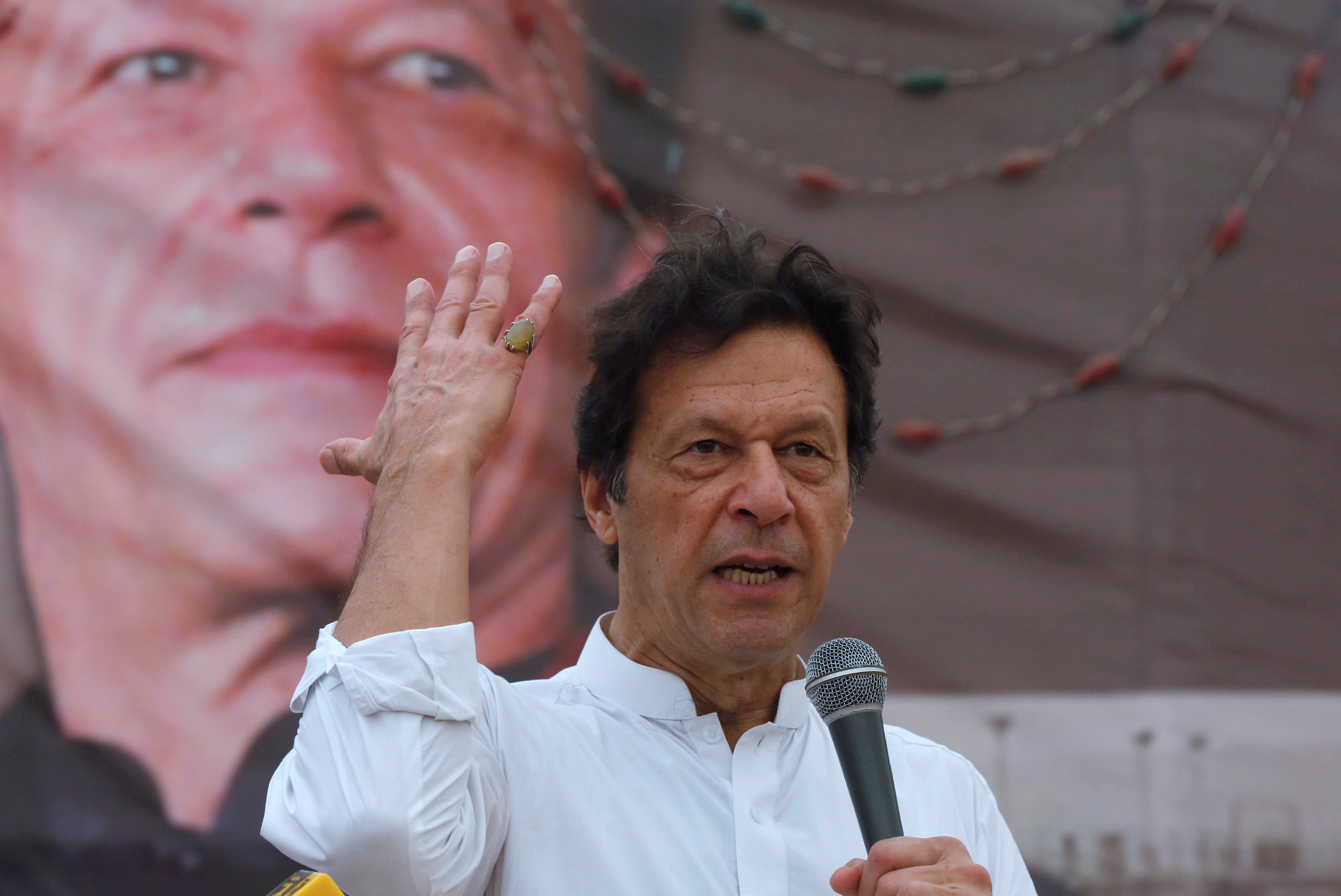 Imran Khan, chairman of the Pakistan Tehreek-e-Insaf (PTI), gestures while addressing his supporters during a campaign meeting ahead of general elections in Karachi, Pakistan, July 4, 2018 (Reuters)