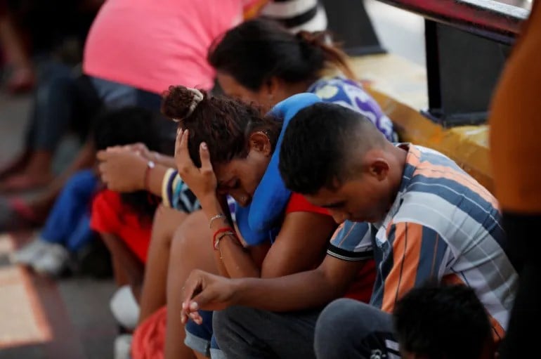 Asylum seekers gather on May 12 on the Matamoros-Brownsville International Border bridge between the US and Mexico, in the wake of Title 42 expiring (Reuters)