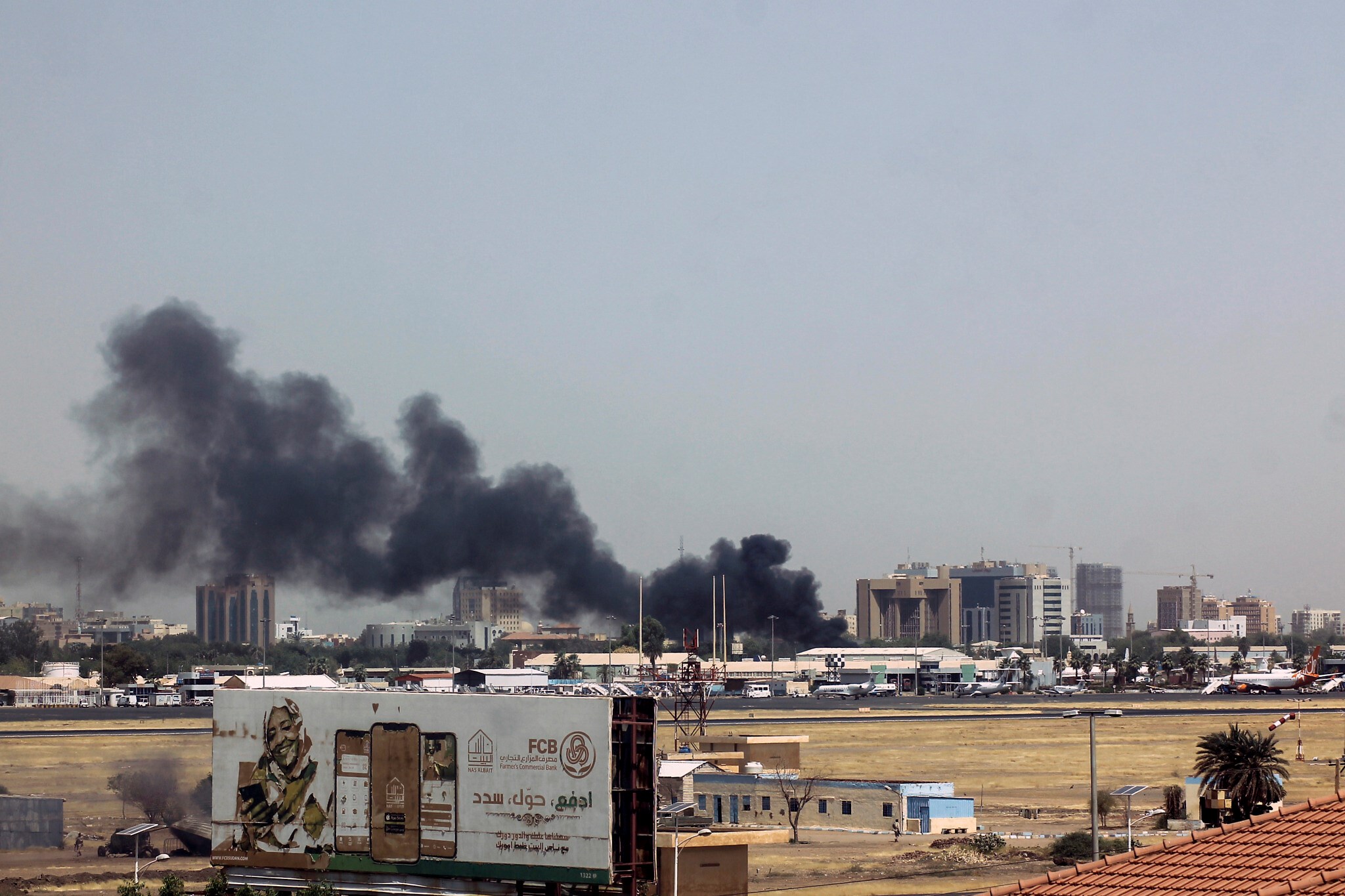 Buildings close to the Khartoum airport burn up in smoke as fighting between the Sudanese Armed Forces and the Rapid Support Forces ensues, Khartoum, Sudan, 15 April 2023. (Reuters)