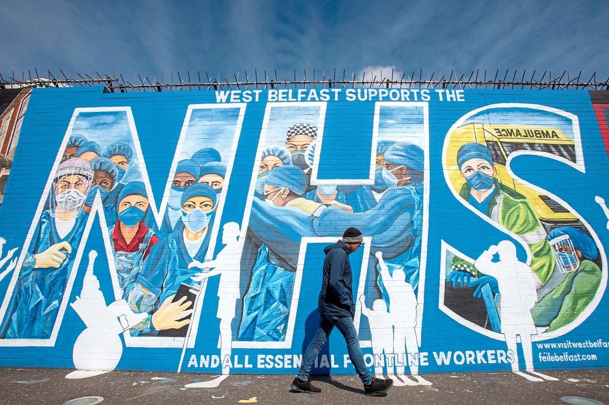 A tribute mural to honour NHS staff and key workers in Belfast, Northern Ireland, created by artists Marty Lyn and Micky Doherty. (AFP)