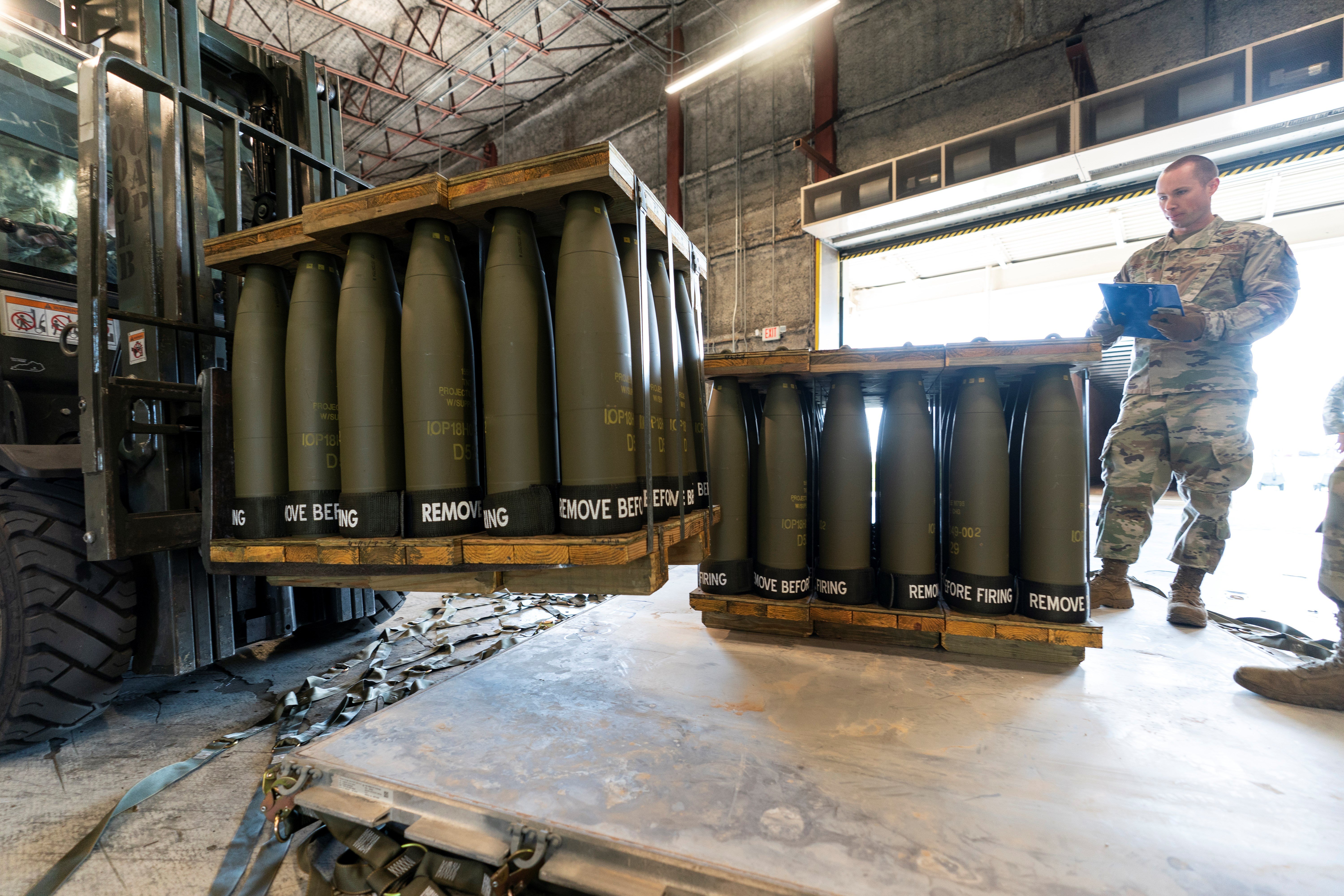 U.S. Air Force Staff Sgt. Cody Brown, right, with the 436th Aerial Port Squadron, checks pallets of 155 mm shells ultimately bound for Ukraine, April 29, 2022, at Dover Air Force Base, Del. (AP)