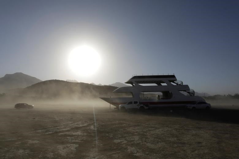 A boat sits on the dried basin of the La Boca dam as more than half of Mexico faces moderate to severe drought conditions, in Santiago, Mexico, March 22, 2022. (Reuters)