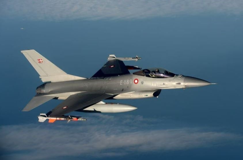 A Danish F16 fighter jet demonstrates the interception of a Belgian air force transport plane as they fly over Denmark, January 14, 2020. (Reuters)