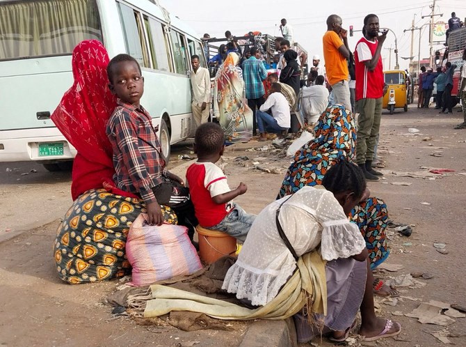 People gather to ride trucks as they flee during clashes between the paramilitary Rapid Support Forces and the army in south Khartoum, Sudan, on April 26, 2023. (Reuters)