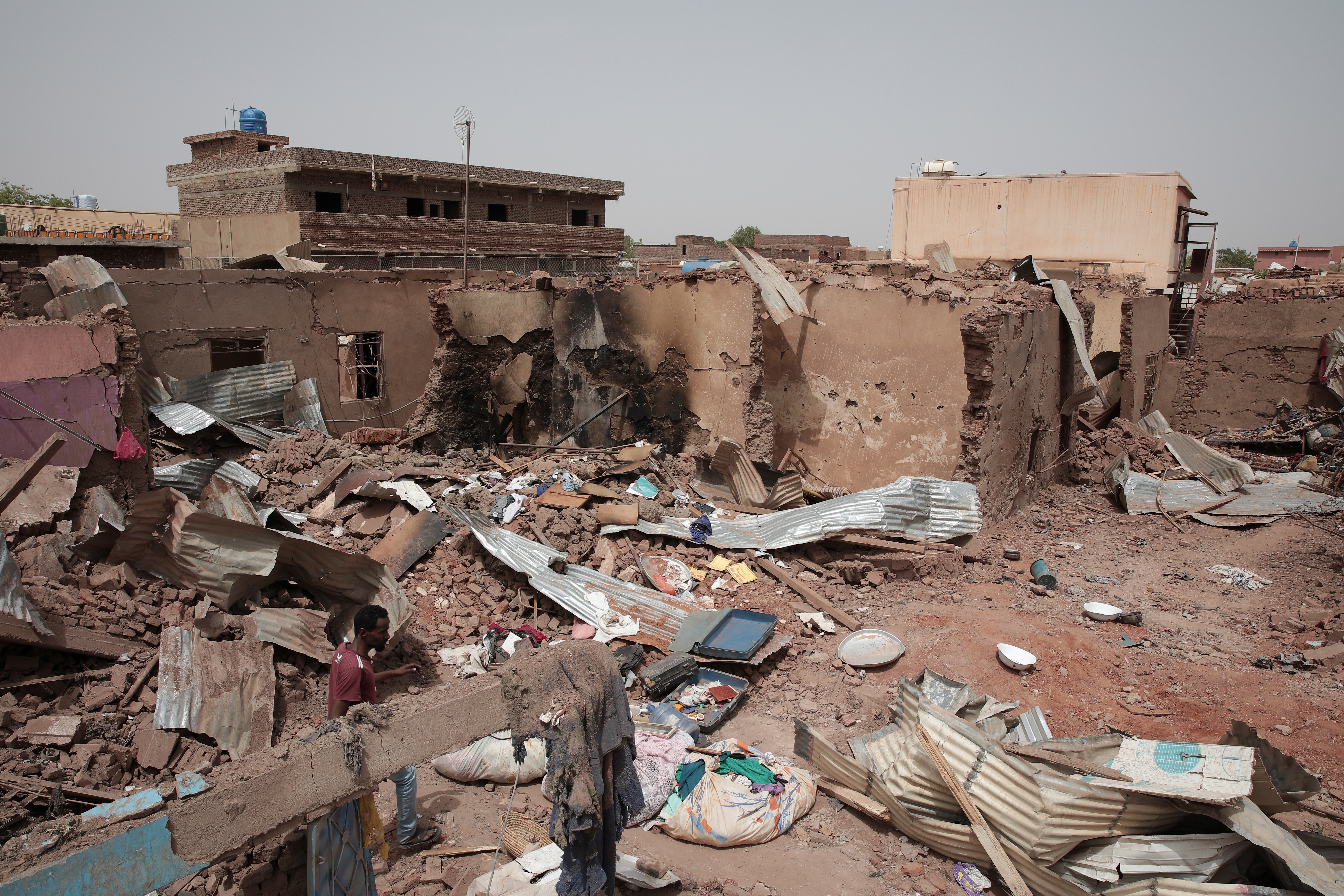 A man walks by a house hit in recent fighting in Khartoum, Sudan, April 25, 2023. (AP)
