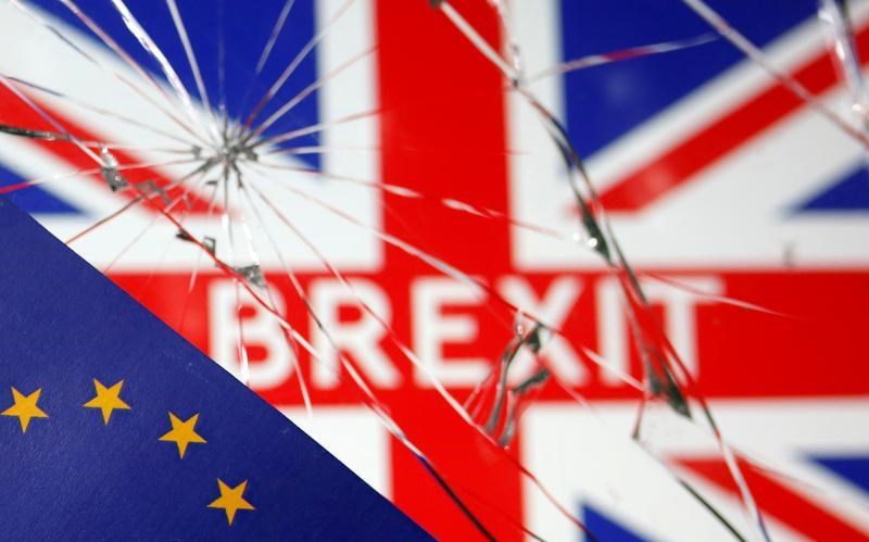 A flag of the EU is placed over broken glass and a flag of the UK with 'BREXIT' printed in its center, January 31 2020. (Reuters)