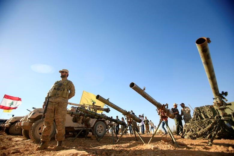 A Hezbollah freedom fighter stands in front of anti-tank artillery weapons in Arsal at the Lebanese-Syrian border, July 29 2017. (Reuters)