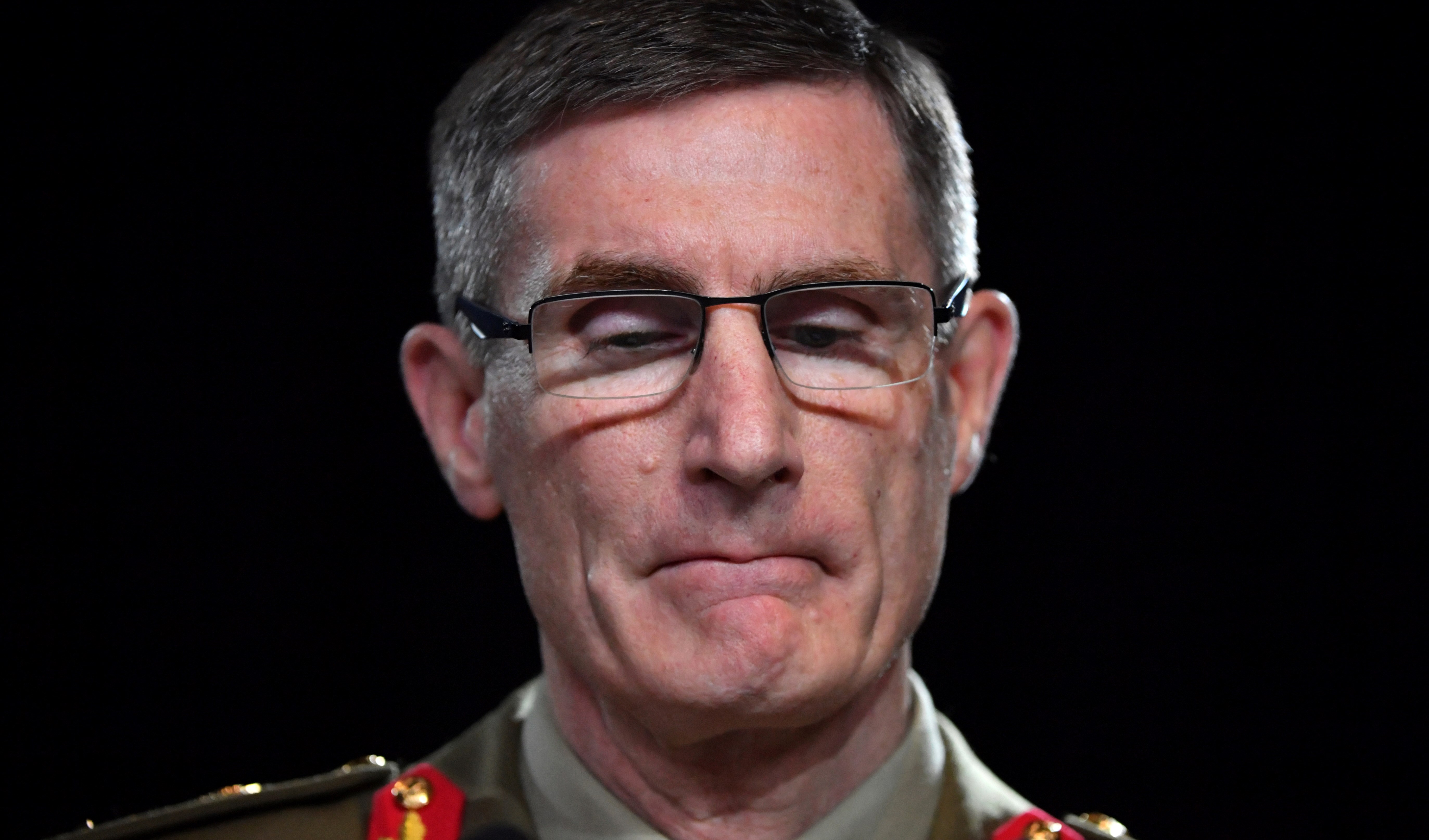 Chief of the Australian Defence Force Gen. Angus Campbell bites his lips while delivering the findings from the Inspector-General of the Australian Defence Force Afghanistan Inquiry, in Canberra, Thursday, Nov. 19, 2020. (AP)