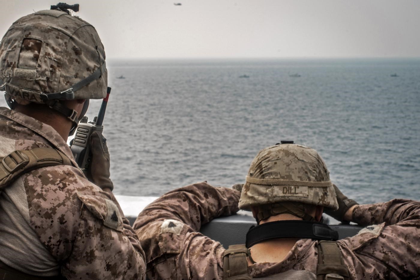 US sailors aboard an amphibious transport dock ship keep watch on Iranian fast inland attack craft in Strait of Hormuz on 12 August (AFP photo/US Navy)