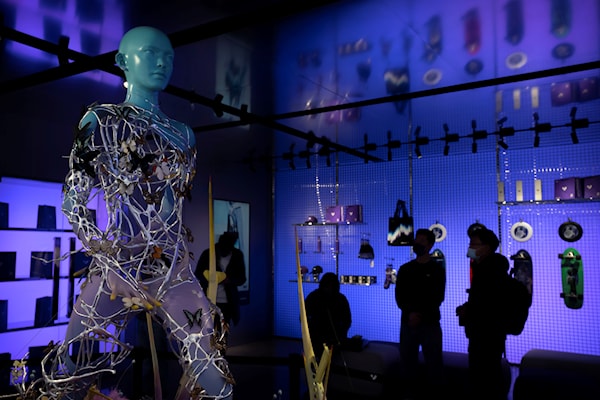 Visitors gather near a statue at a concept shop for Chinese electric car maker Jidu in Beijing, Tuesday, Feb. 14, 2023. (AP)