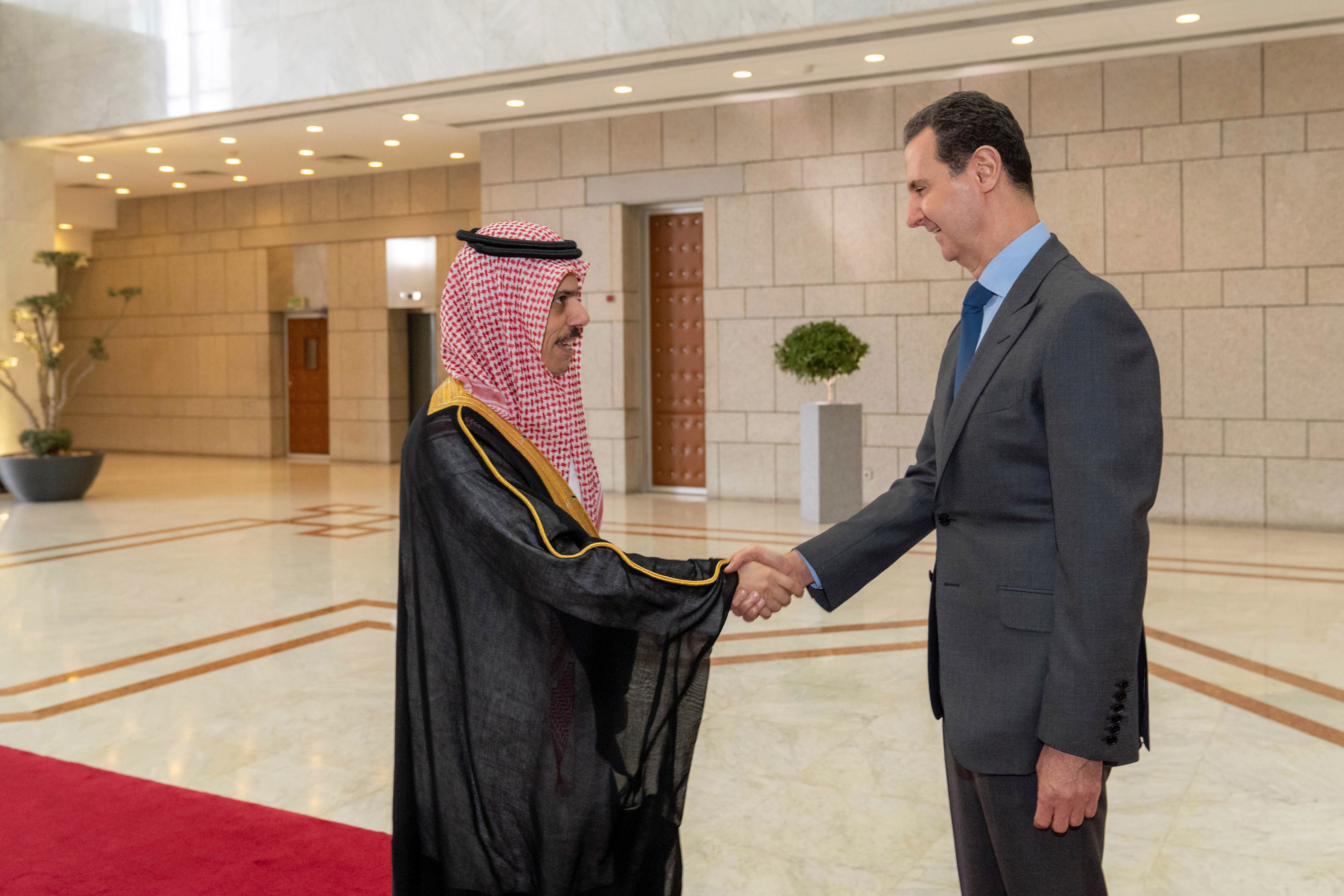 Syrian President Bashar Assad welcomes Saudi Minster of Foreign Affairs Faisal bin Farhan, before their meeting in Damascus, Syria, Tuesday, April 18, 2023.  (SANA via AP)