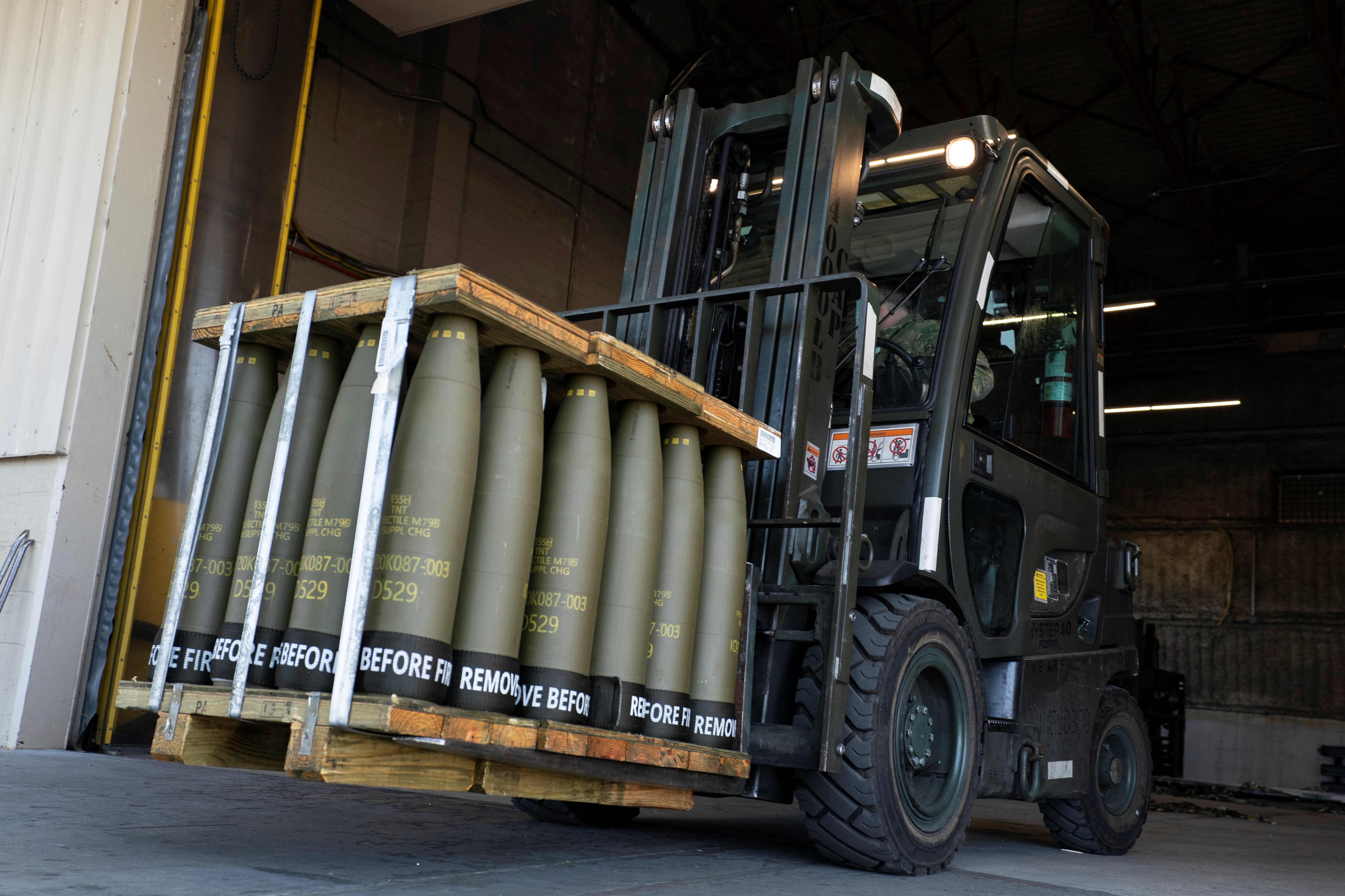 Airmen with the 436th Aerial Port Squadron use a forklift to move 155 mm shells ultimately bound for Ukraine, April 29, 2022, at Dover Air Force Base, Delaware. (AP)