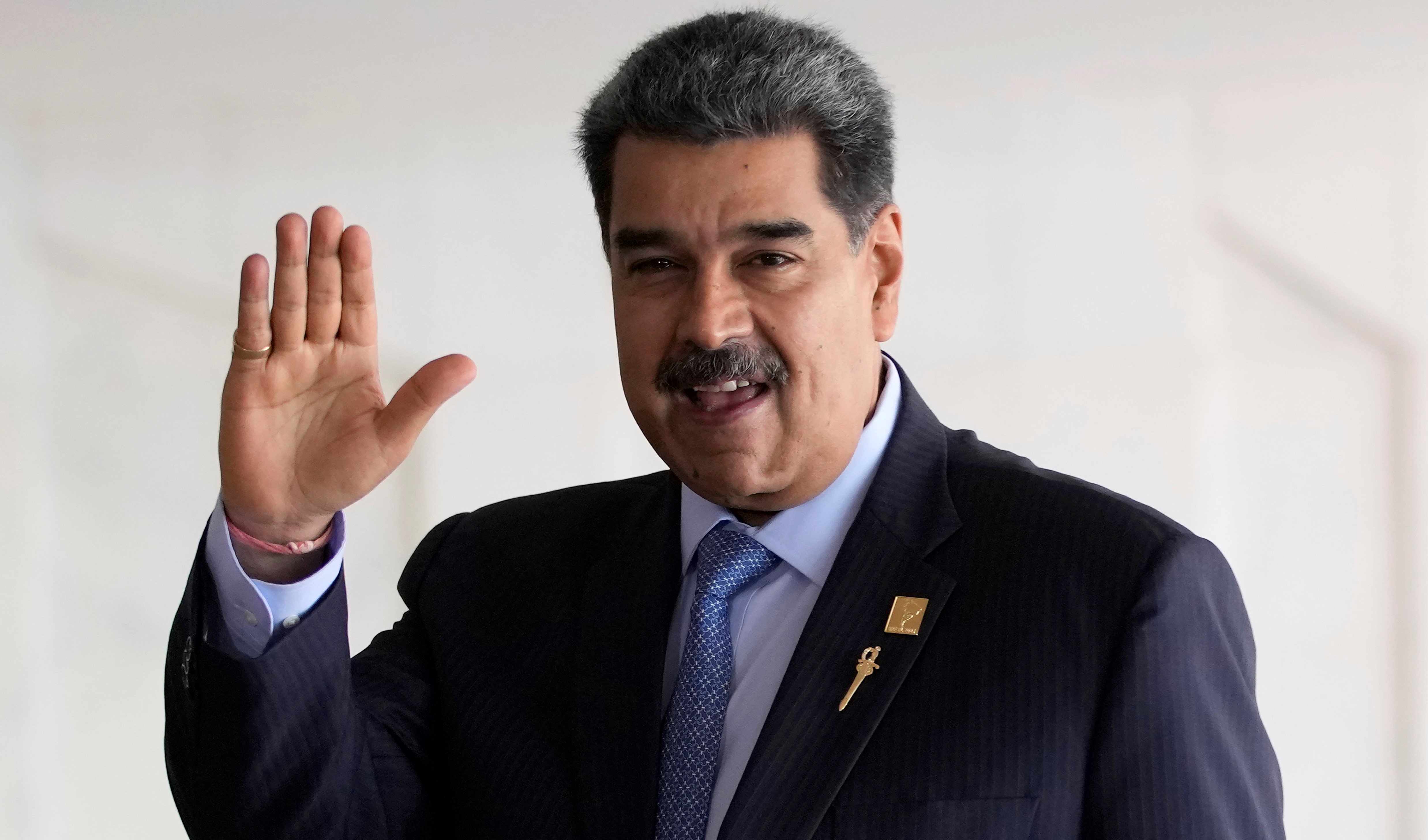 Venezuela's President Nicolas Maduro waves upon arrival for the South American Summit at Itamaraty palace in Brasilia, Brazil, on May 30, 2023. (AP)