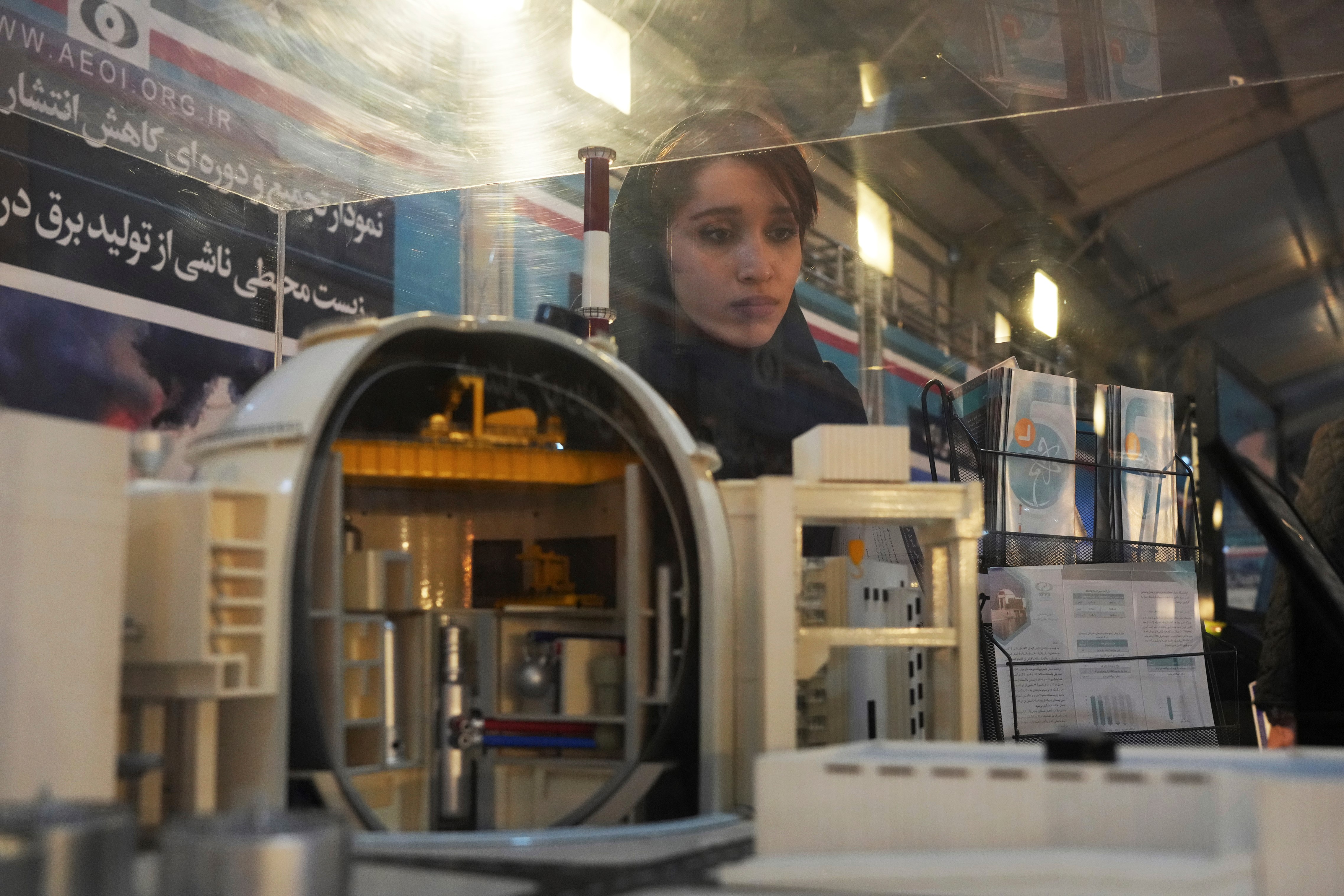 A student looks at a model of Bushehr nuclear power plant in an exhibition of the country's nuclear achievements, in Tehran, Iran, Wednesday, Feb. 8, 2023 (AP Photo/Vahid Salemi)