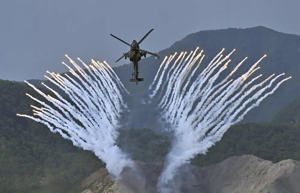A South Korean Apache AH-64 helicopter fires flares during a joint military drill held by South Korea and the US in Pocheon, South Korea, June 15 2023.