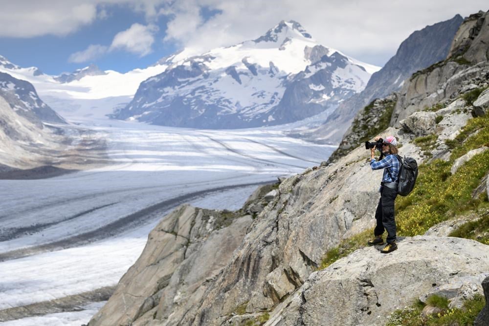 In this July 21, 2020 file photo, Swiss photographer David Carlier takes photographs of the Swiss Aletsch glacier, the longest glacier in Europe, in Fieschertal, Switzerland. (AP)