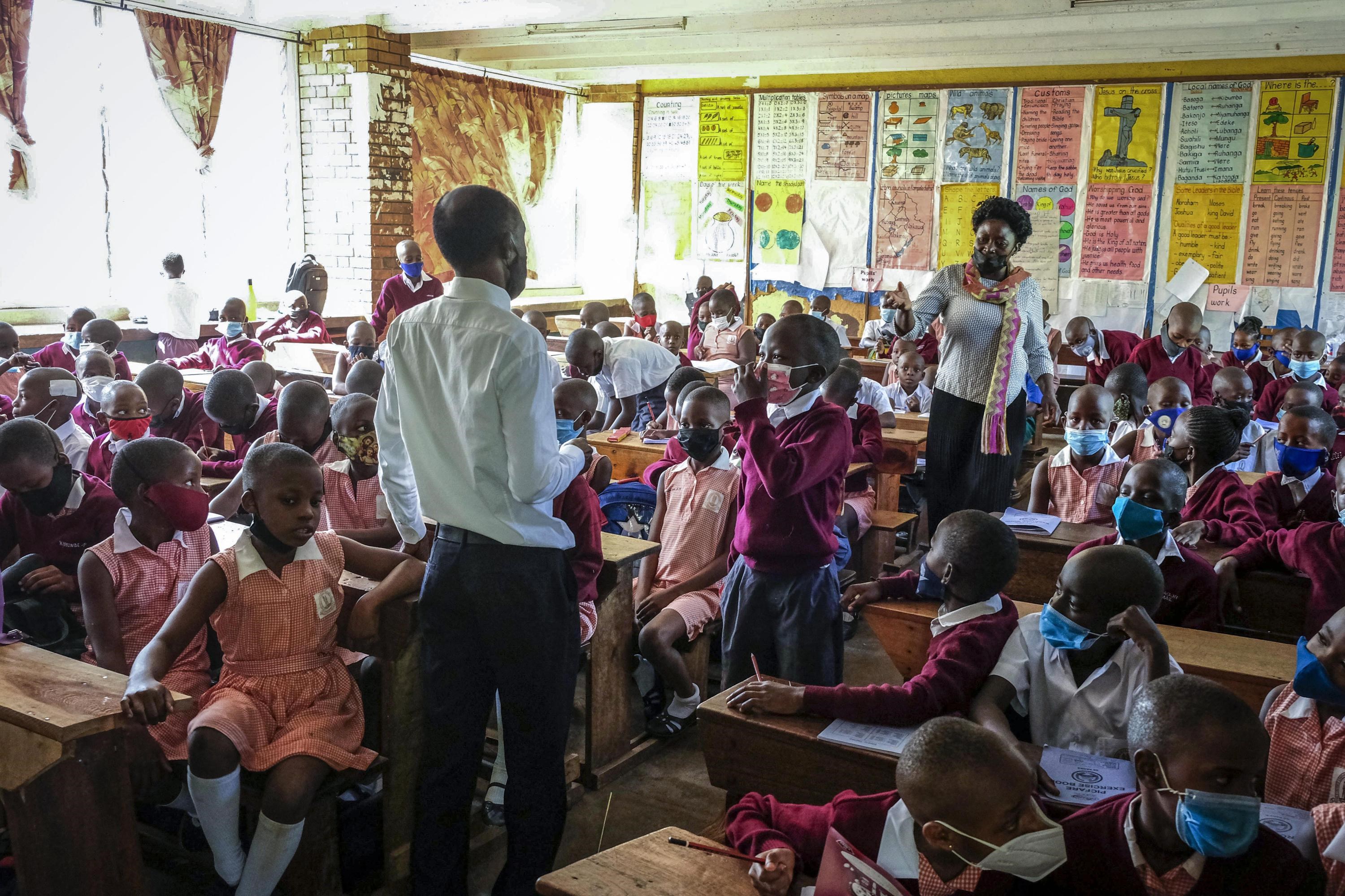 Pupils wear face masks as they attend class at Kitante Primary School in Kampala, Uganda Monday, Jan. 10, 2022. Uganda's schools reopened to students on Monday, ending the world's longest school disruption due to the COVID-19 pandemic. (AP)