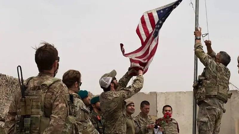 US soldiers lowering the US national flag during a handover ceremony to the Afghan National Army in Helmand province, May 2, 2021. (AFP)