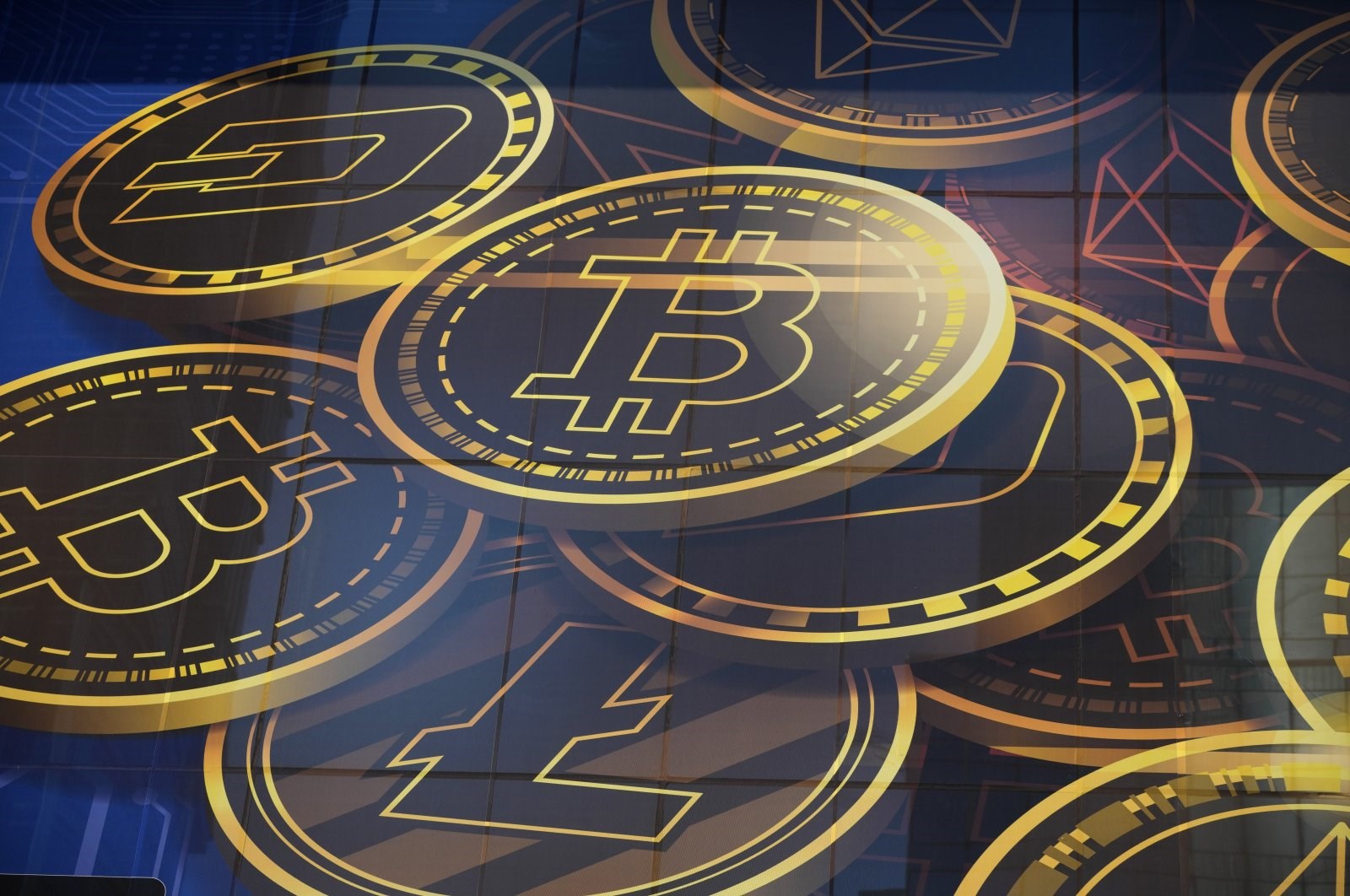 An advertisement of Bitcoin, one of the cryptocurrencies, is displayed on a building in Hong Kong, November 18, 2021 (AP)