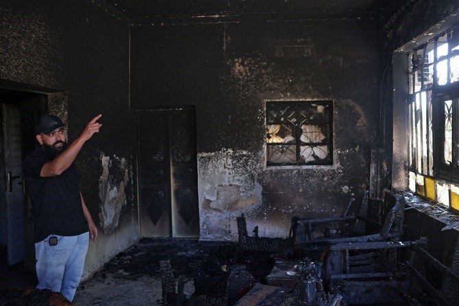 A Palestinian gestures inside his home, which was set on fire by Israeli settlers, in Turmus Aya near Ramallah, on June 22, 2023. (AFP)