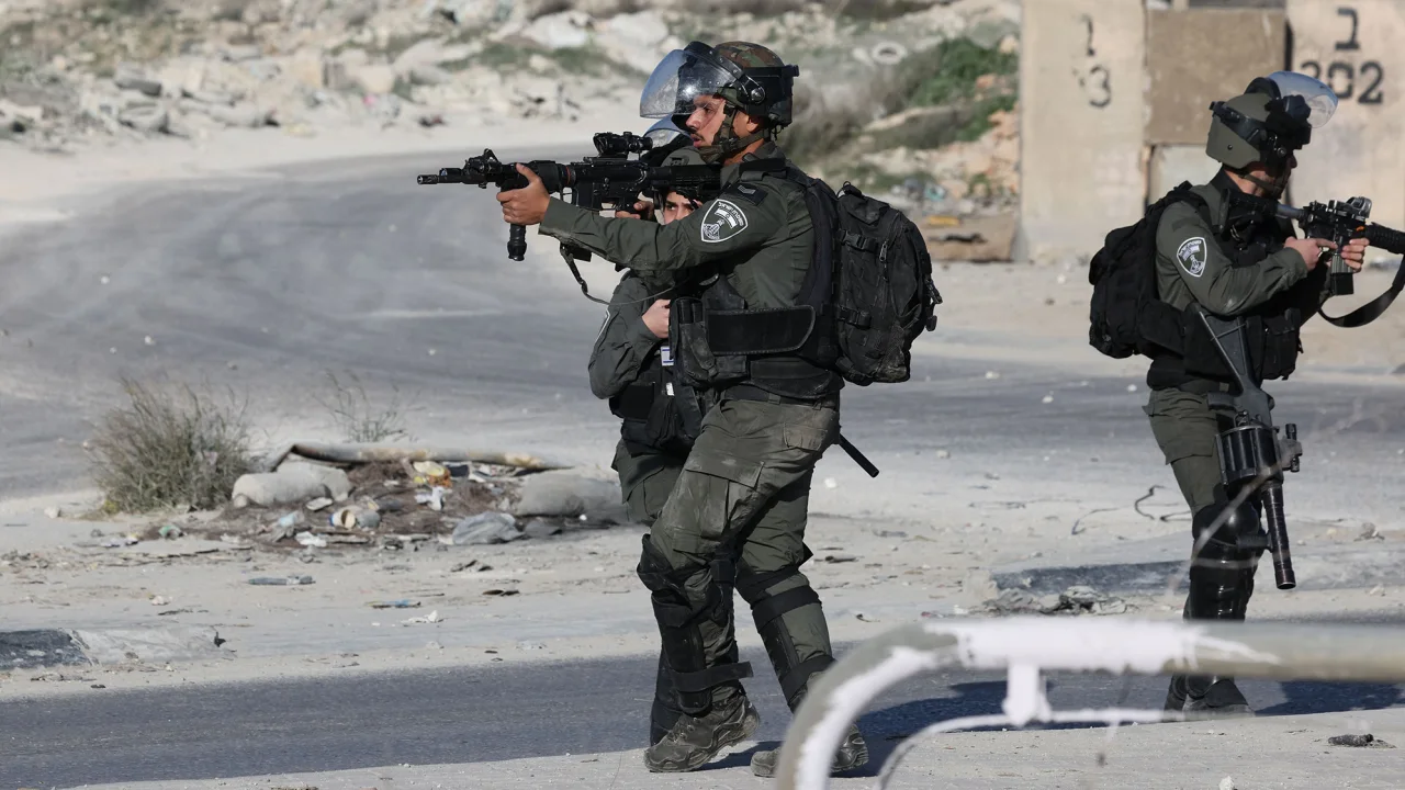  IOF aim their weapons during confrontations with Palestinians in the West Bank town of Al-Ram on January 27, 2023, following a raid on the Jenin refugee camp. (AFP)