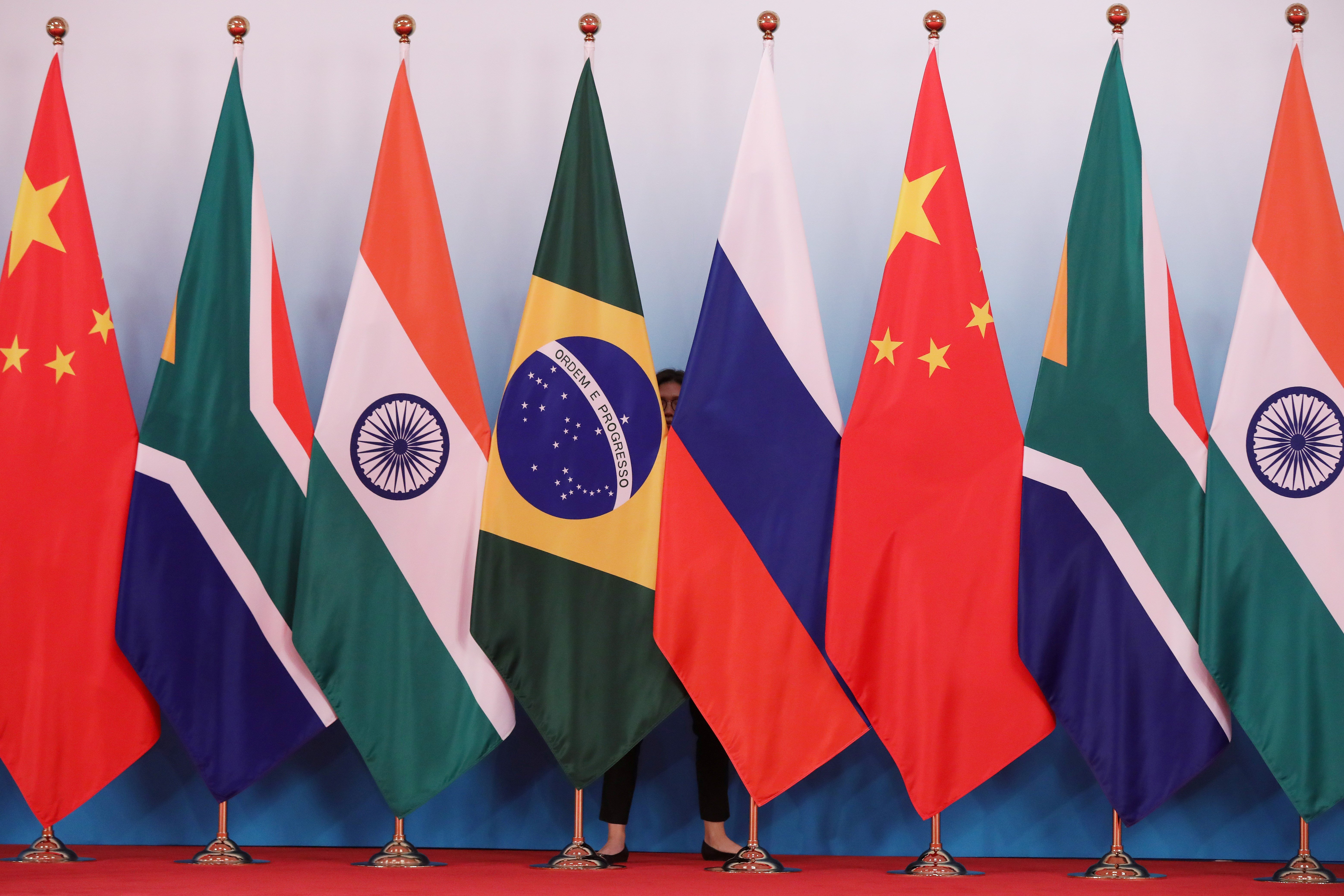 The national flags of China, South Africa, India, Russia, and Brazil are put up ahead of a group photo of the participants in the BRICS summit, Xiamen, China, September 4 2017. (Reuters)