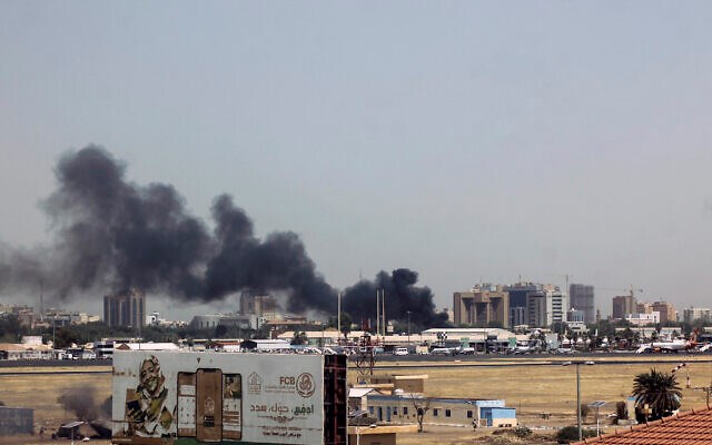 Heavy smoke bellows above buildings in the vicinity of the Khartoum's airport on April 15, 2023, amid clashes in the Sudanese capital. (AFP)