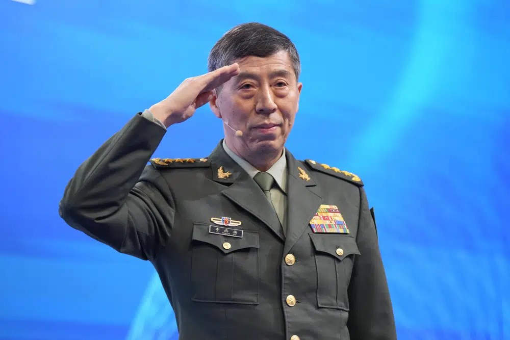 Chinese Minister of National Defense, Li Shangfu, performs military salute before speaking at Shangri-La Dialogue summit in Singapore, June 4 2023. (AP)