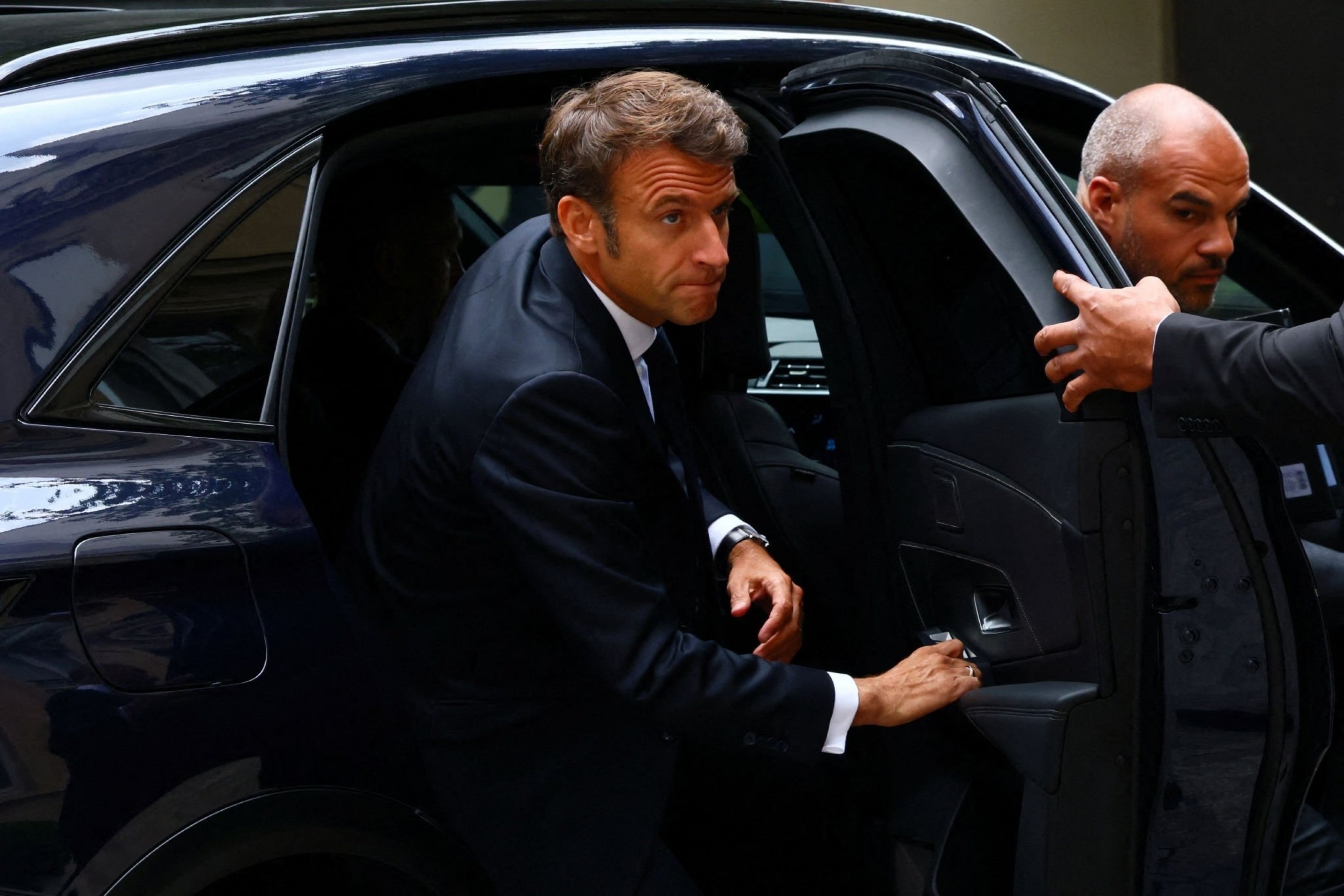 French President Emmanuel Macron exits a car to arrive to an inter ministerial crisis unit meeting after French police murdered Nahel M. in cold blood, Paris, France, 30 June 2023. (AFP)