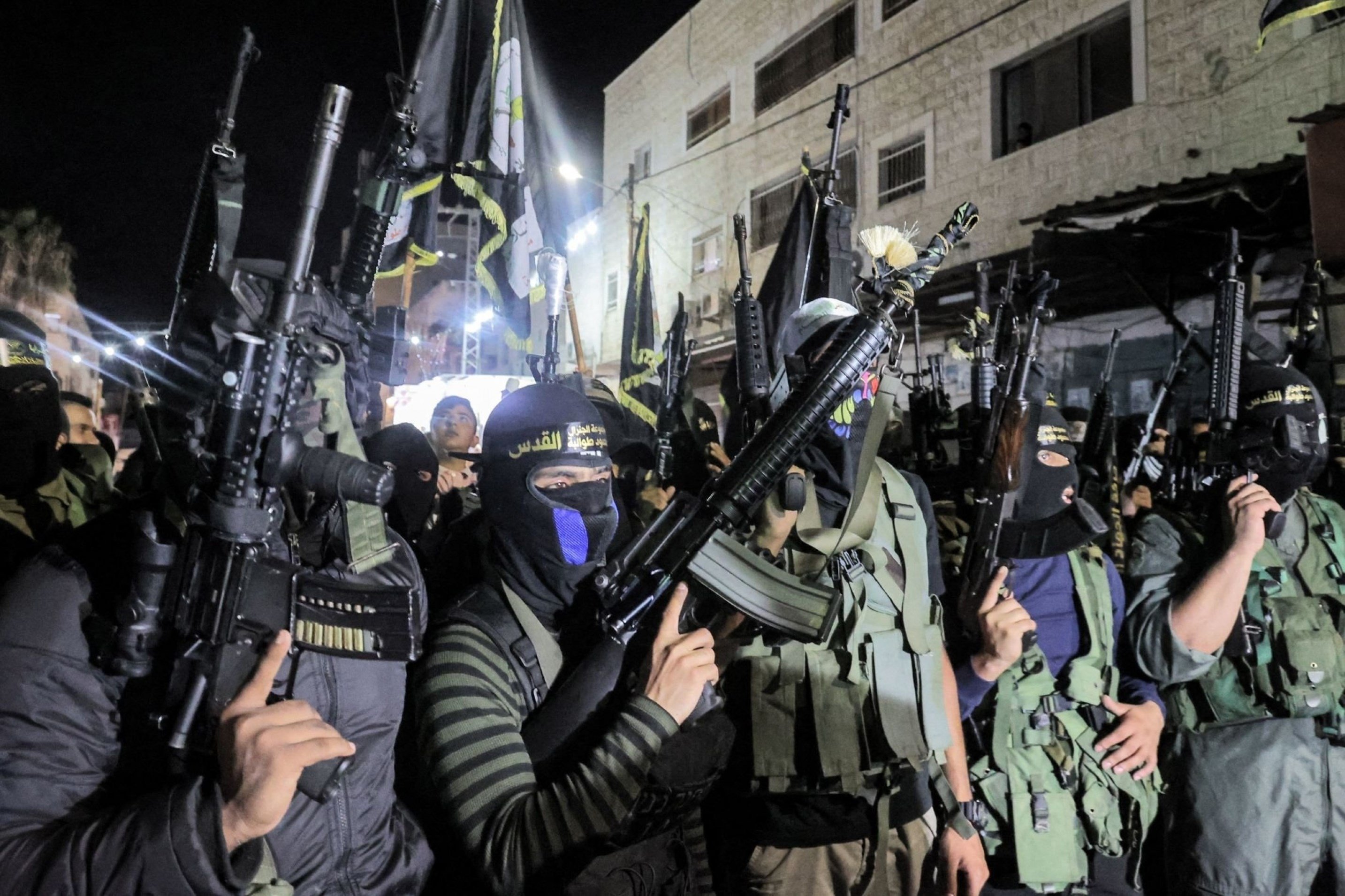 Resistance fighters of the Al-Quds Brigades march alongside their comrades from the Al-Aqsa Martyrs' Brigades and Al-Qassam Brigades through the Jenin camp, occupied West Bank, Palestine, August 18 2021. (AFP)