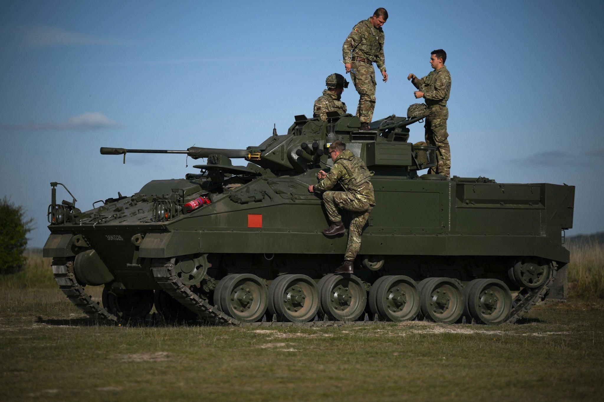 British military personnel mount an a Warrior infantry fighting vehicle during a live fire combat training with Ukrainian recruits near Durrington, UK, October 11 2022. (AFP)