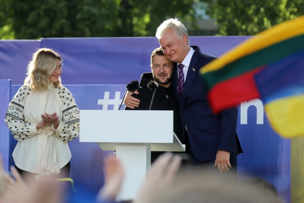 Ukrainian President Volodymyr Zelensky (centre) gets a hug by Lithuania's President Gitanas Nauseda after addressing the crowd at Lukiskiu Square in Vilnius on July 11, 2023, during a NATO Summit. (AFP)