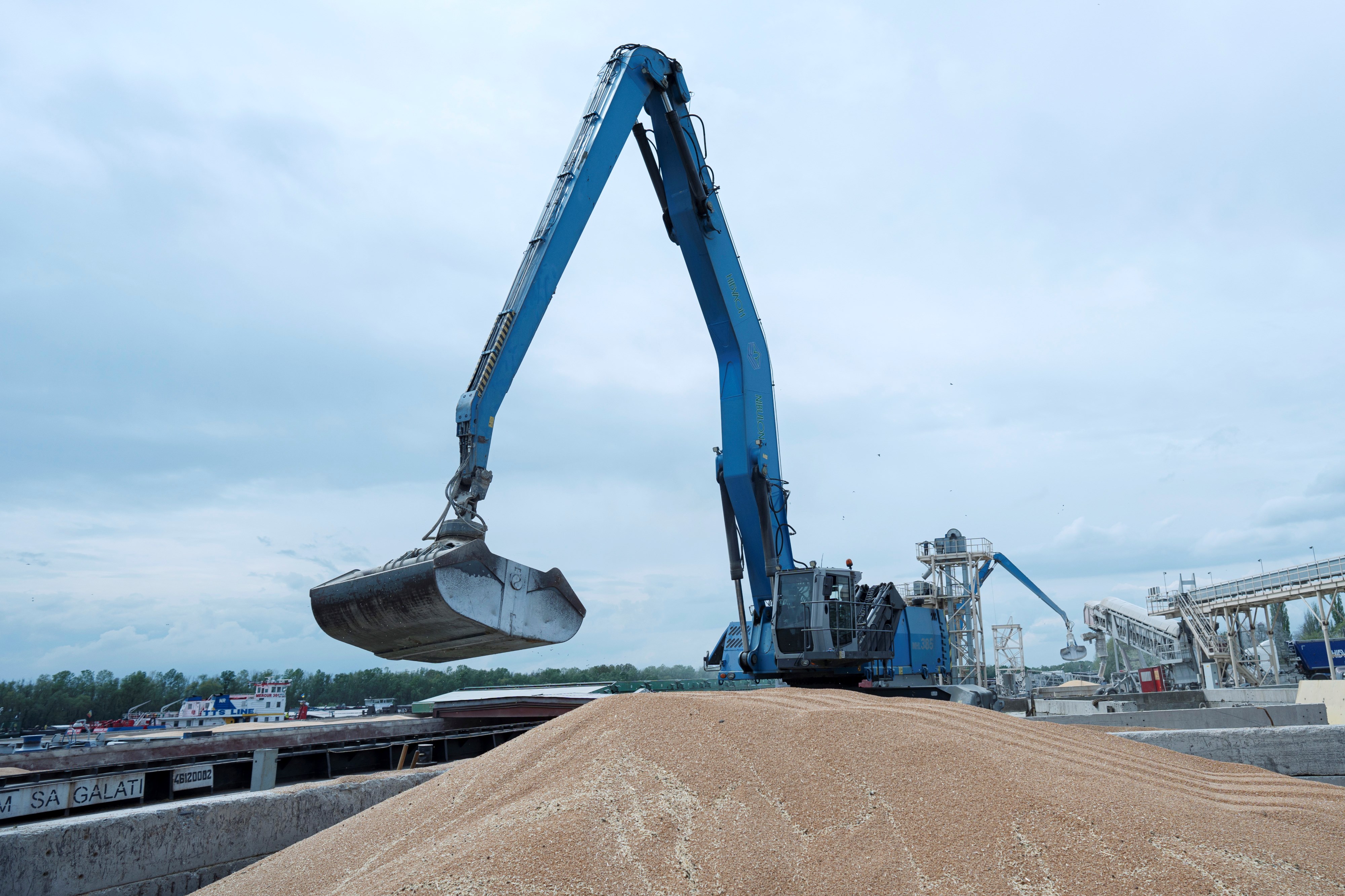 An excavator loads grain into a cargo ship at a grain port in Izmail, Ukraine, on April 26, 2023. (AP)