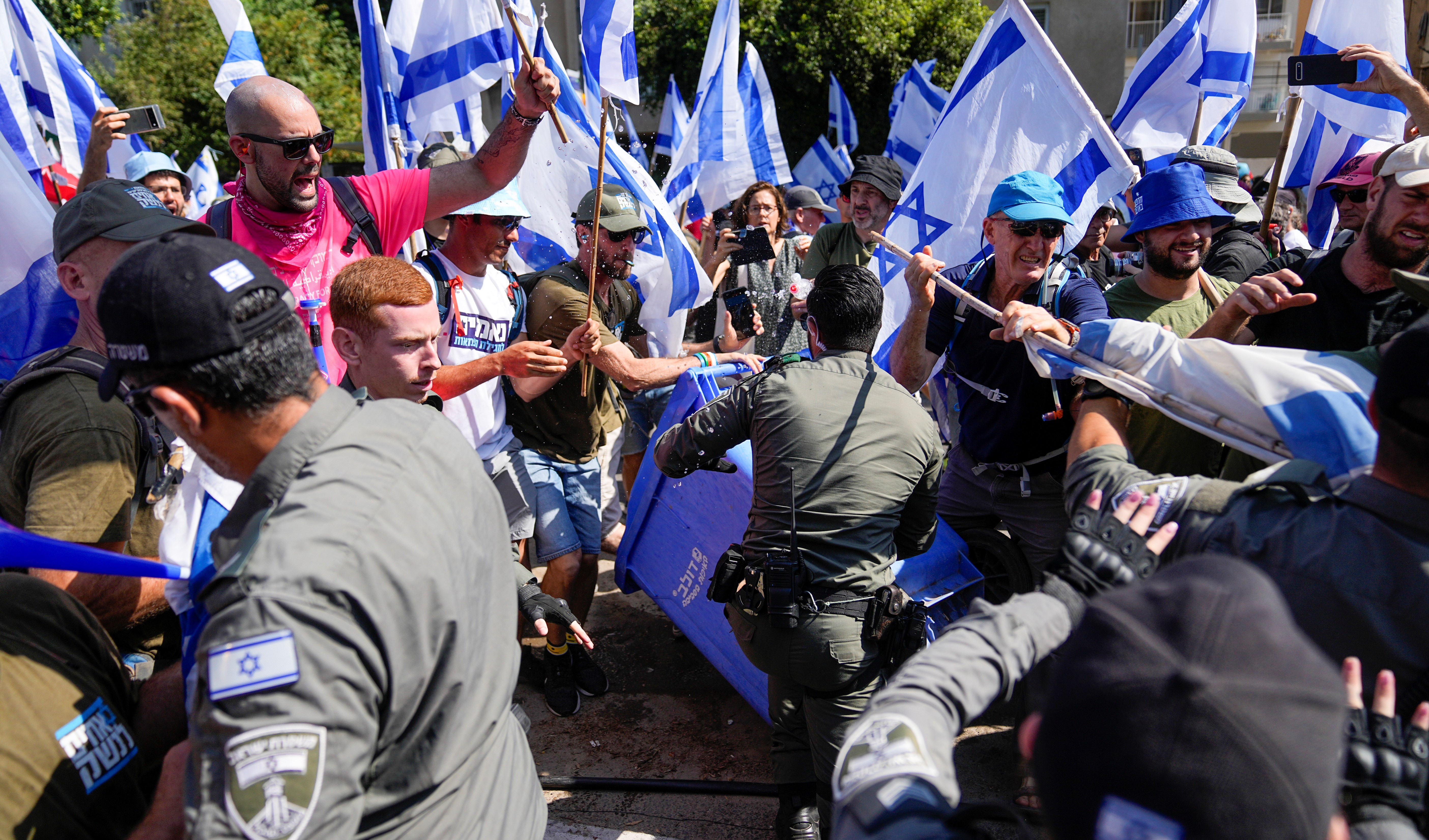 Israelis protest against plans by Prime Minister Benjamin Netanyahus government to overhaul the judicial system scuffle with police in Tel Aviv, Israel, Tuesday, July 18, 2023. (AP)