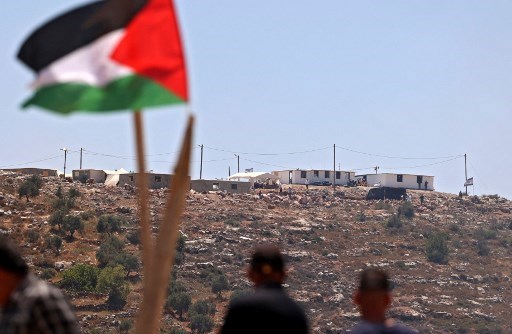 Palestinian protesters attend a demonstration against the Evyatar settlement outpost, south of Nablus, on June 4, 2021, in the West Bank. (AFP)