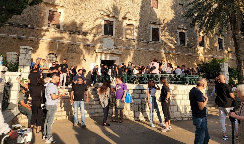 Palestinian Christians stand in front of the Mar Elias Church and Monastery following confrontations in the face of the provocative and barbaric storming conducting by Israeli settlers on July 23, 2023. (Social Media)