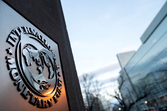 The seal for the International Monetary Fund is seen near the World Bank headquarters (R) in Washington, DC. (AFP)