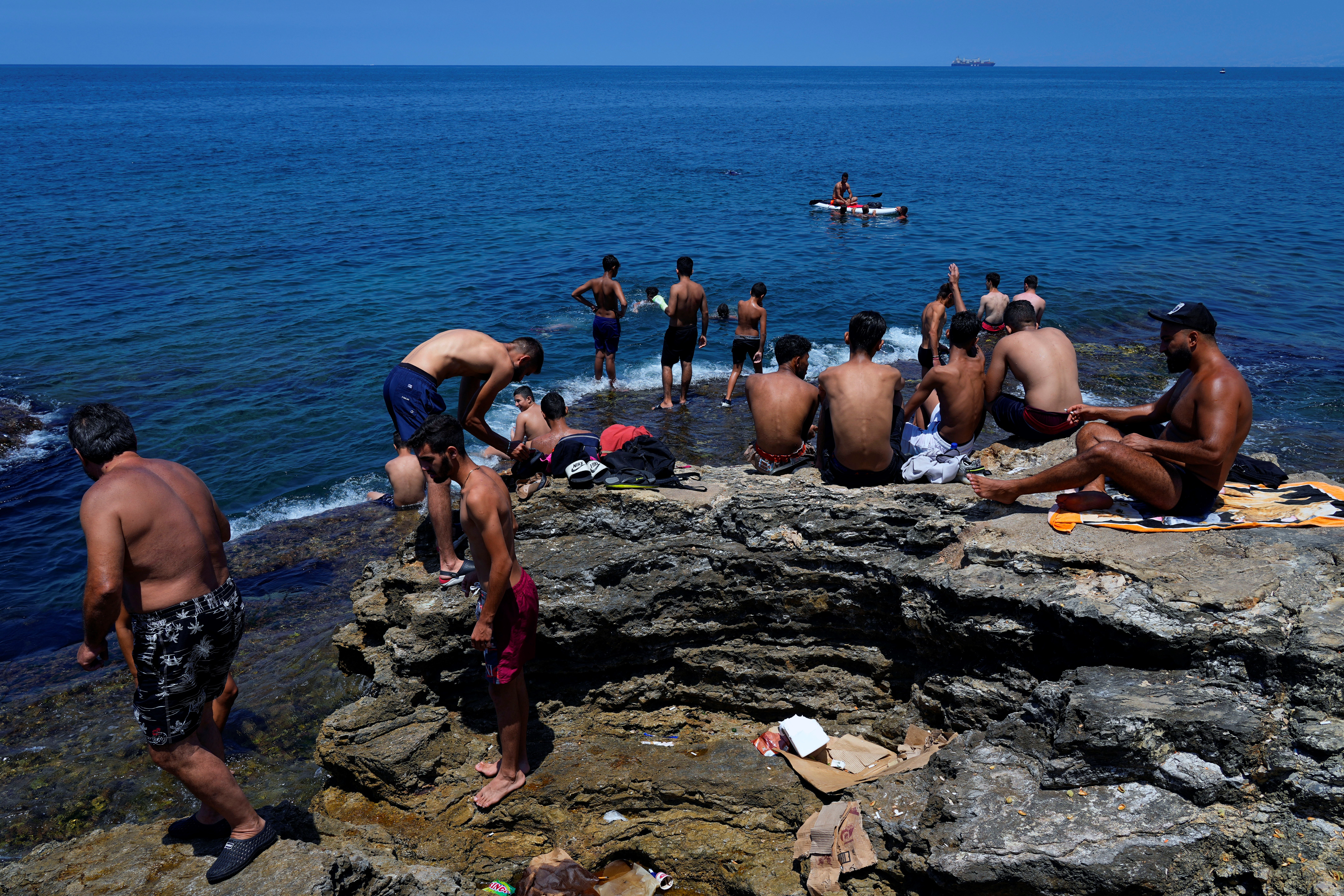 People cool down on a sweltering hot day at the Mediterranean Sea in Beirut, Lebanon, Sunday, July 23, 2023. (AP)
