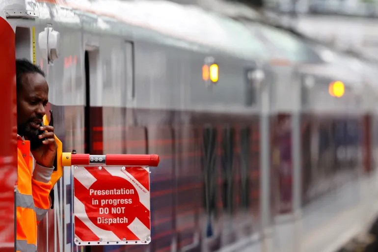 A railway worker in the UK performing his duties (AFP)