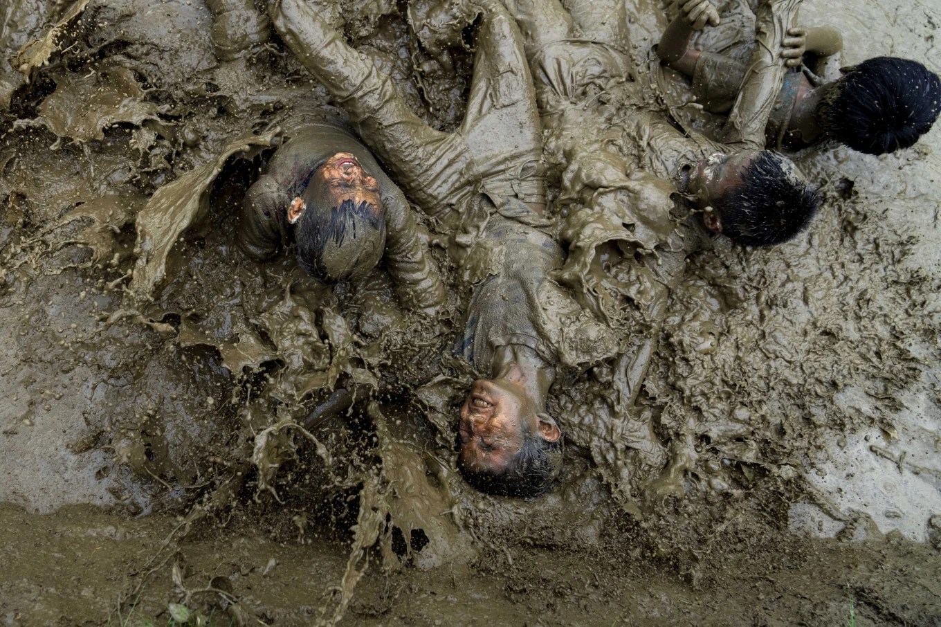 Children play in the mud in a paddy field during Asar Pandra, or paddy planting day at Bahunbesi, Nuwakot District, 30 miles North from Kathmandu, Nepal, Friday, June 30, 2023. (AP)