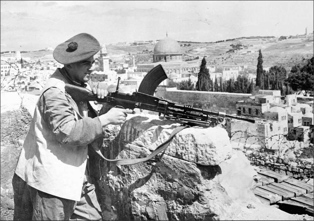 A British soldier aims a machine gun in Al-Quds during the British colonial occupation of Palestine  (AFP)