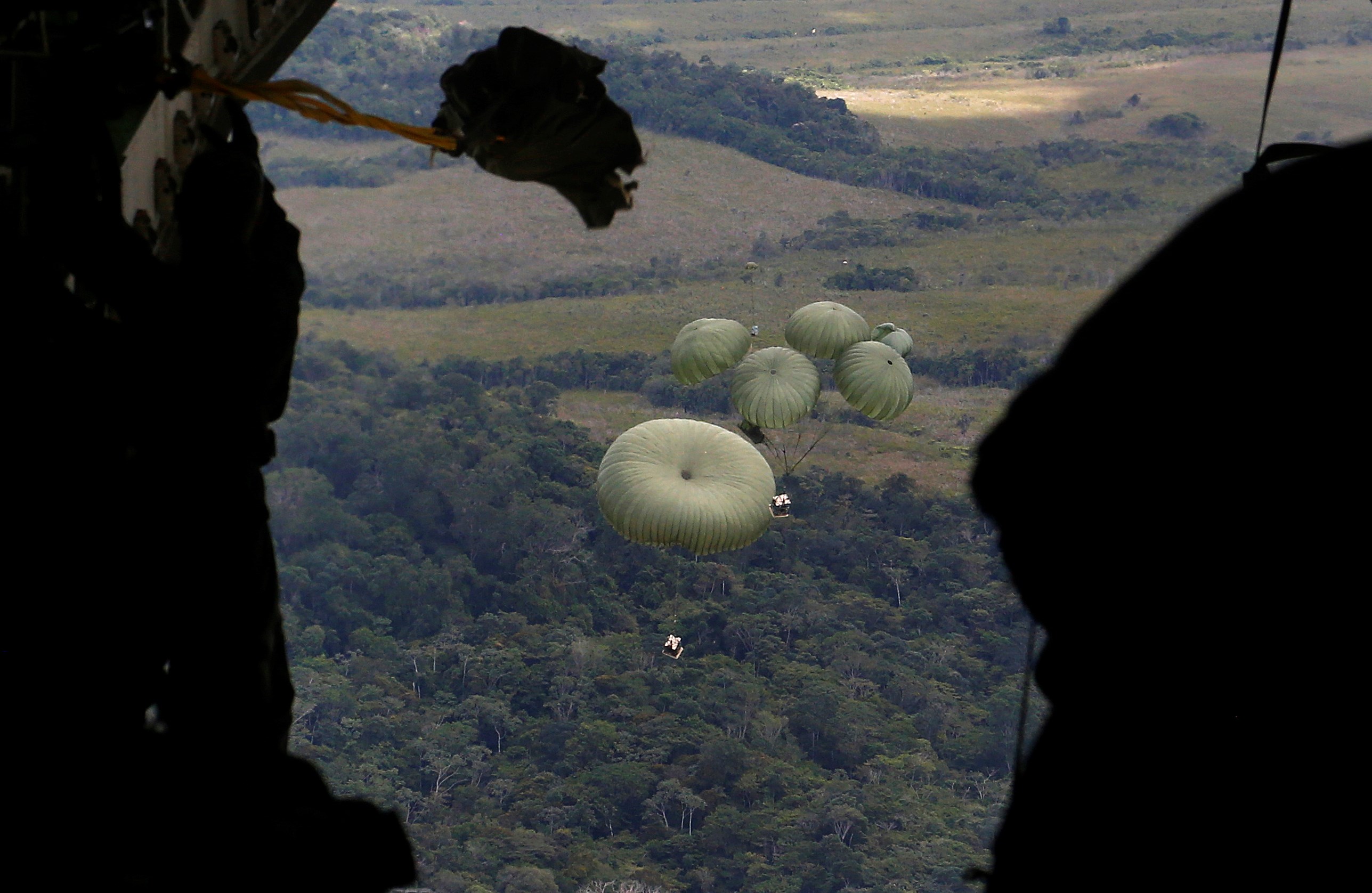 Food is airdropped from a military transport aircraft to the Surucucu military base, to be delivered to Yanomami indigenous people, in Alto Vista, Roraima state, Brazil, Jan 26, 2023 (AP)