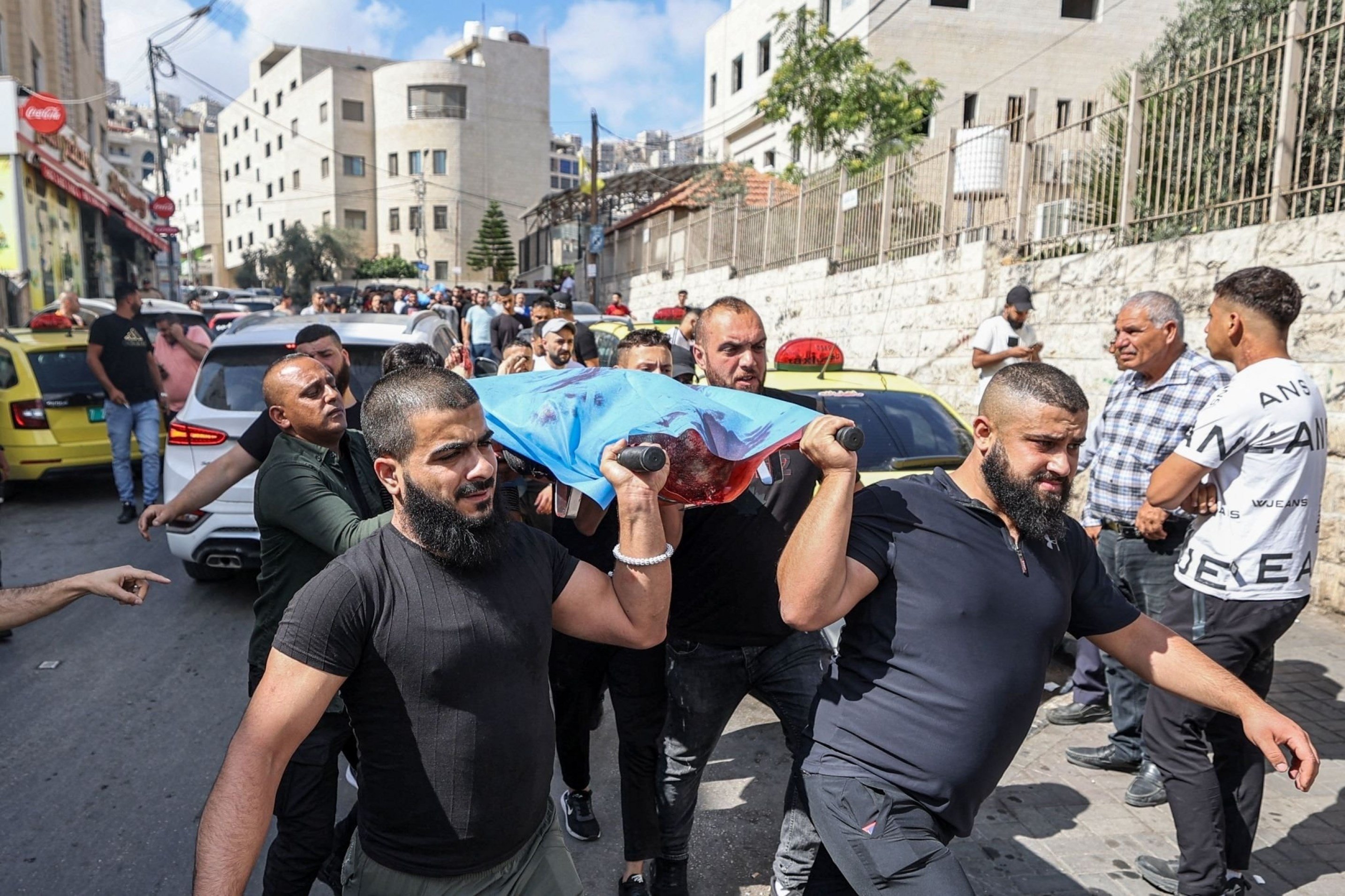 Men carry the body of Palestinian who was martyred after Israeli occupation forces shot him dead in the Nablus. occupied West Bank, Palestine, July 7 2023. (AFP)