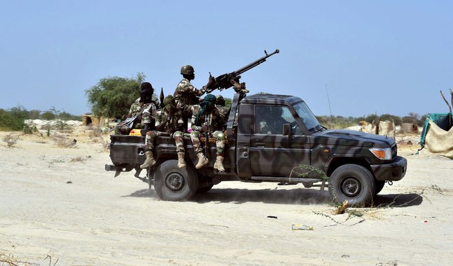 Niger soldiers ride in a military vehicle on May 25, 2015 in Malam Fatori, in northern Nigeria, near the border with Niger. (AFP)